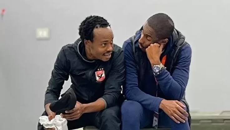 Percy Tau in conversation with team mate