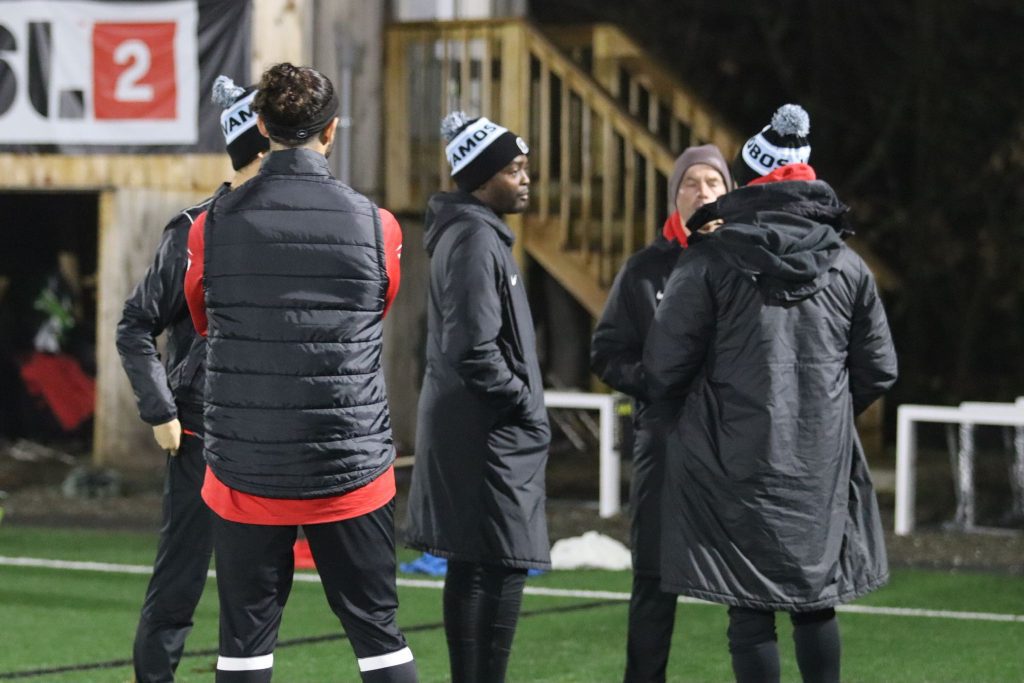 Young Pep coaches discussing the game.