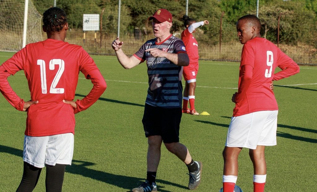 Peter Butler discussing the potions for the Botswana team.