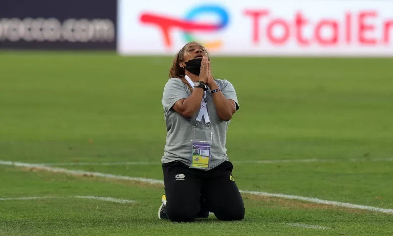 desiree Ellis praying on the field.