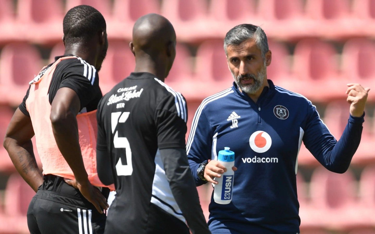 Jose Riveiro with two Orlando Pirates players