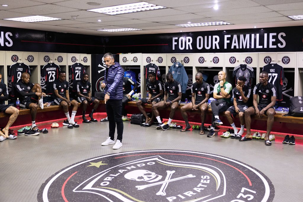 Orlando Pirates players being addressed by head coach Jose Riveiro